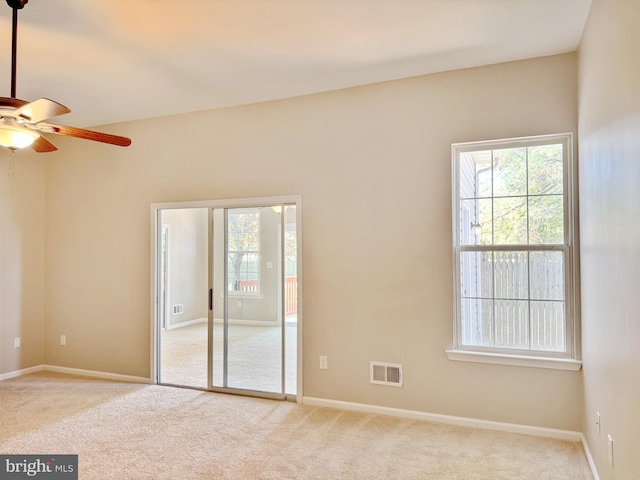 unfurnished room featuring visible vents, baseboards, ceiling fan, and carpet floors