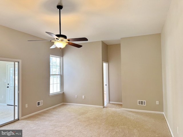 unfurnished room featuring visible vents, a ceiling fan, and light colored carpet