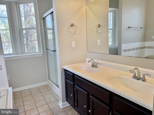 bathroom featuring a sink, tile patterned floors, and a healthy amount of sunlight