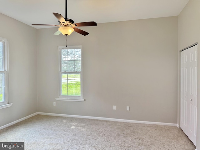 unfurnished bedroom featuring a closet, carpet, and multiple windows