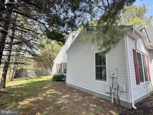 view of side of property featuring fence