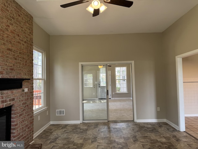 interior space featuring ceiling fan, visible vents, and plenty of natural light