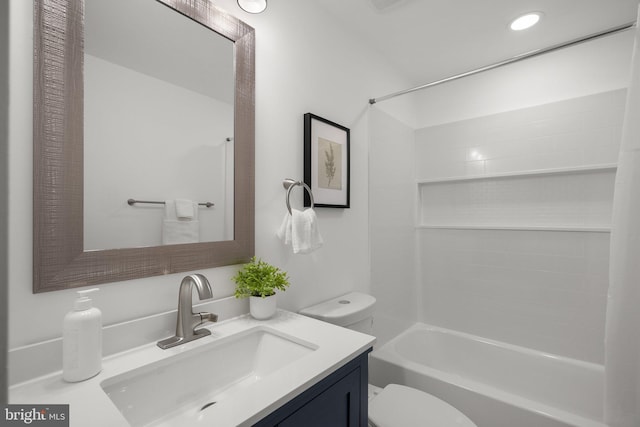 bathroom featuring vanity, recessed lighting, tub / shower combination, and toilet