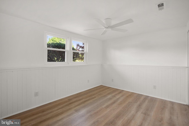 3604 Ripplingbrook Ct, Bowie, MD 20721 - unfurnished room with visible vents, a ceiling fan, wood finished floors, and a wainscoted wall
