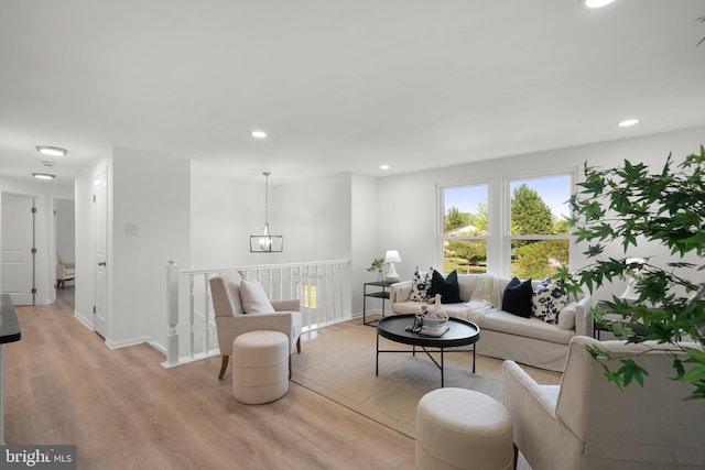 living room with recessed lighting, light wood finished floors, and baseboards