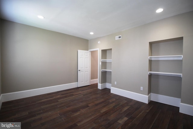 unfurnished bedroom featuring dark wood-style flooring, baseboards, visible vents, and recessed lighting