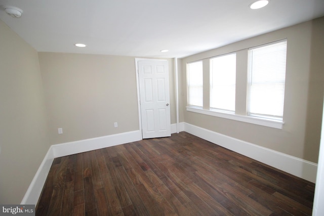 unfurnished room featuring recessed lighting, baseboards, and dark wood-style floors