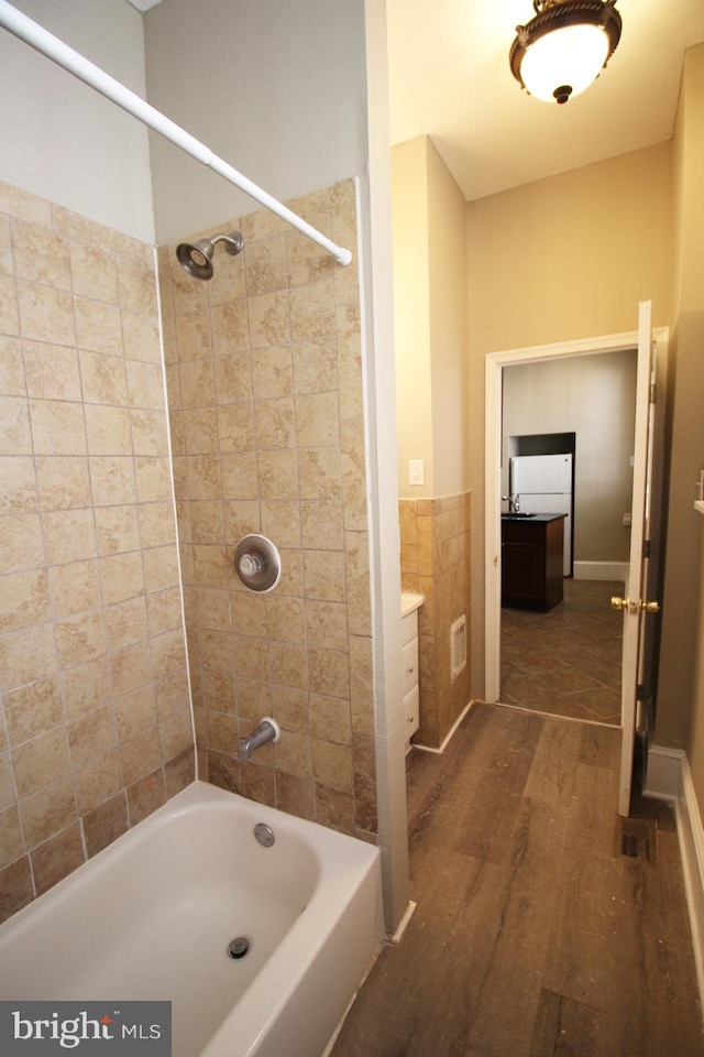 full bathroom with  shower combination and wood finished floors