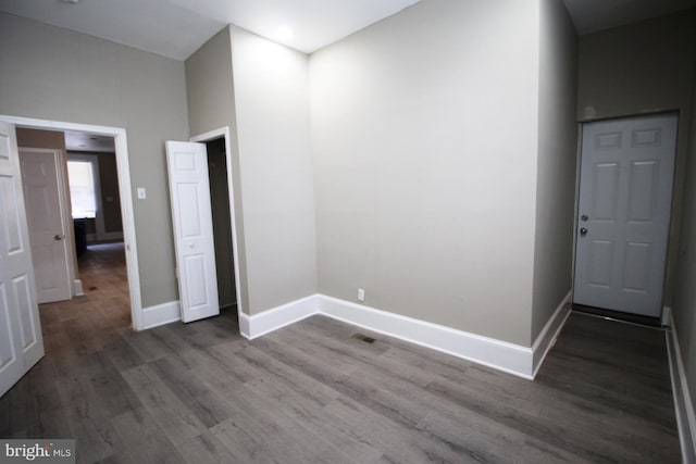 interior space featuring wood finished floors, baseboards, and recessed lighting