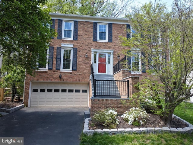 5849 Colfax Ave, Alexandria, VA 22311 - view of front facade with asphalt driveway, an attached garage, and brick siding