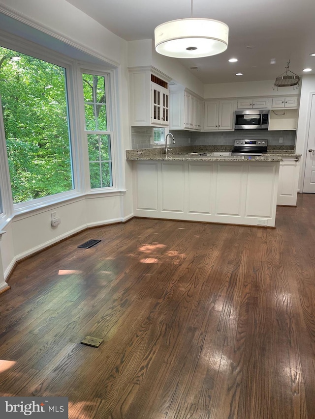 5849 Colfax Ave, Alexandria, VA 22311 - kitchen with appliances with stainless steel finishes, white cabinets, dark wood-style floors, and light stone counters