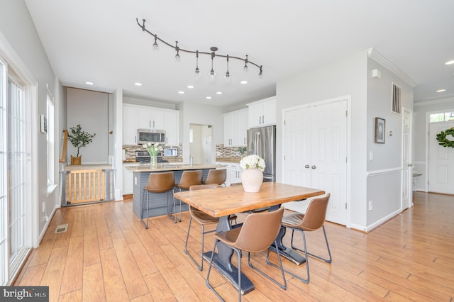 109 Manila Pl, Stephenson, VA 22656 - dining area featuring light wood-type flooring, recessed lighting, crown molding, and baseboards