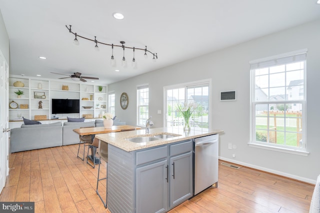 109 Manila Pl, Stephenson, VA 22656 - kitchen with stainless steel dishwasher, a sink, gray cabinets, light wood-style floors, and a center island with sink
