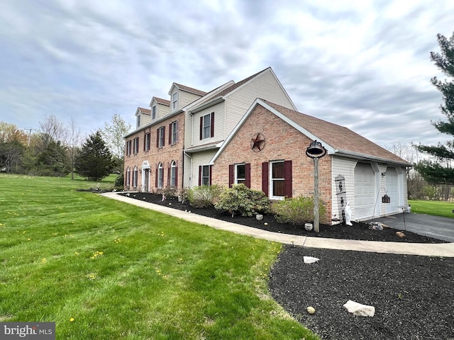 view of front of property featuring brick siding, aphalt driveway, a front lawn, and an attached garage