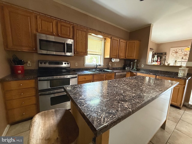 11 Morlatton Rd, Douglassville, PA 19518 - kitchen with stainless steel appliances, a sink, crown molding, light tile patterned flooring, and a center island