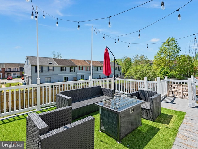 deck with a yard, fence, outdoor lounge area, and a residential view