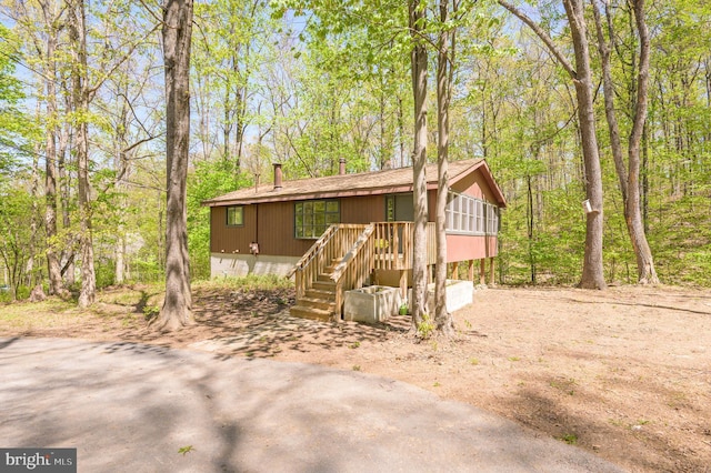 view of front of house featuring roof with shingles