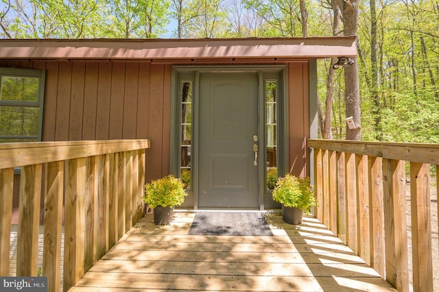 doorway to property featuring a wooden deck