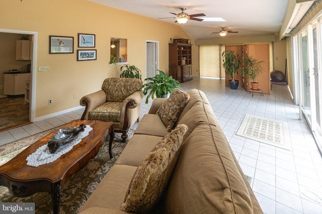 living room featuring baseboards, ceiling fan, vaulted ceiling, and tile patterned floors
