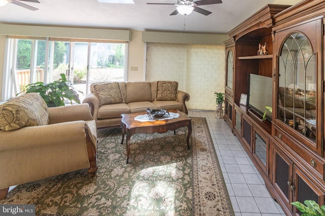 living area featuring a ceiling fan and light tile patterned floors