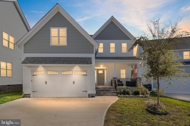 craftsman-style home with a garage, covered porch, a shingled roof, and concrete driveway