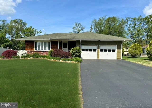 ranch-style home with driveway, a front lawn, and a garage
