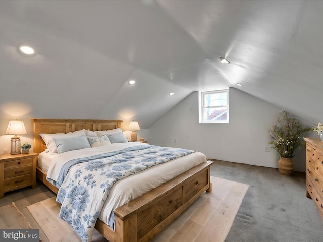 bedroom featuring lofted ceiling and light carpet