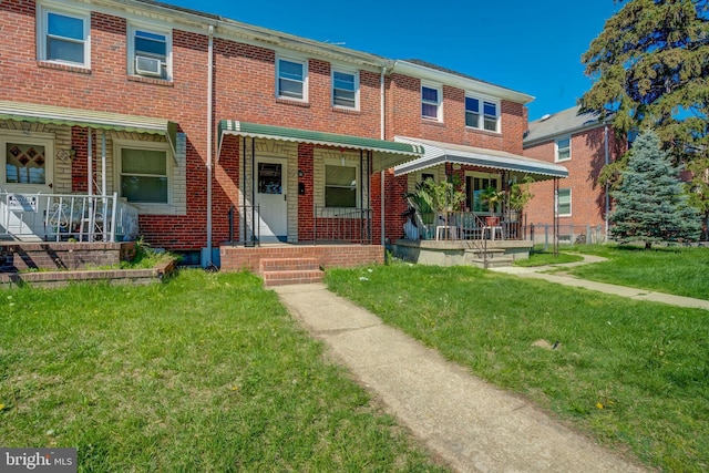 126 Kingston Rd, Middle River, MD 21220 - townhome / multi-family property with covered porch, a front yard, and brick siding