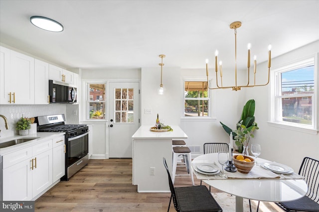 577 Lucia Ave, Baltimore, MD 21229 - kitchen with a sink, appliances with stainless steel finishes, plenty of natural light, and light wood-style floors