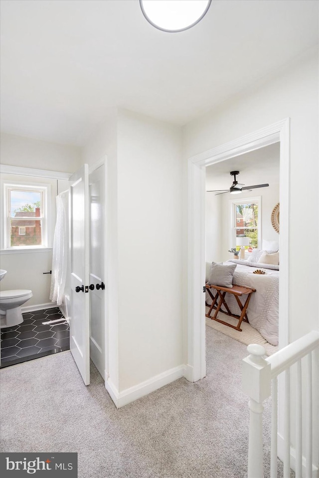 corridor featuring carpet floors and baseboards