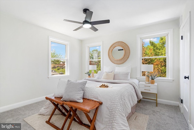 carpeted bedroom featuring baseboards and ceiling fan