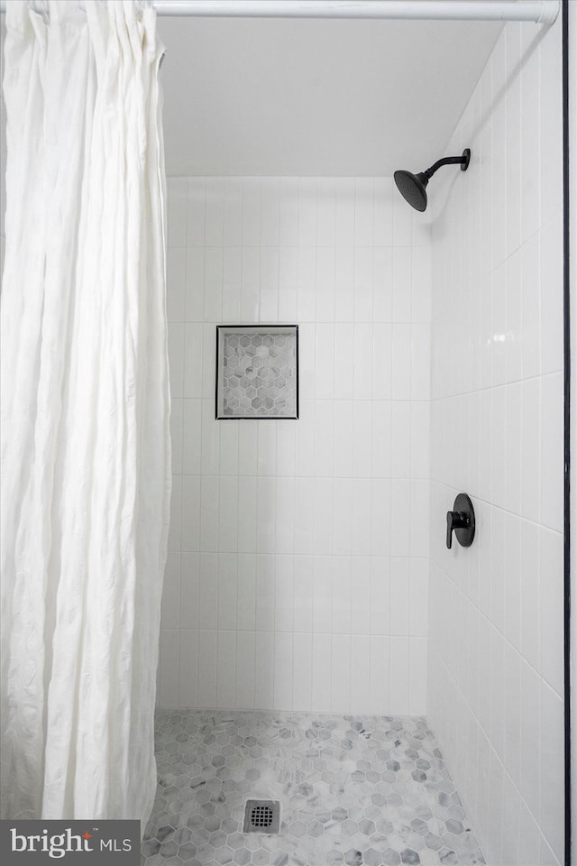 bathroom with a stall shower and visible vents