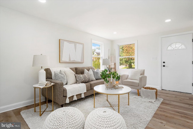 living room featuring recessed lighting, baseboards, and wood finished floors