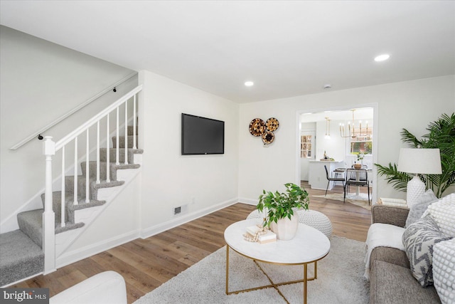 577 Lucia Ave, Baltimore, MD 21229 - living area with an inviting chandelier, recessed lighting, wood finished floors, and stairway
