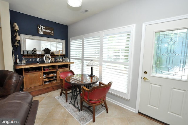 dining space featuring a healthy amount of sunlight, light tile patterned floors, baseboards, and visible vents