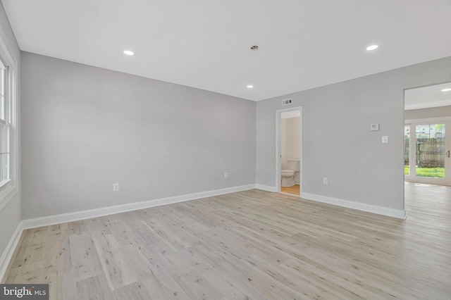 spare room with baseboards, recessed lighting, light wood finished floors, and visible vents