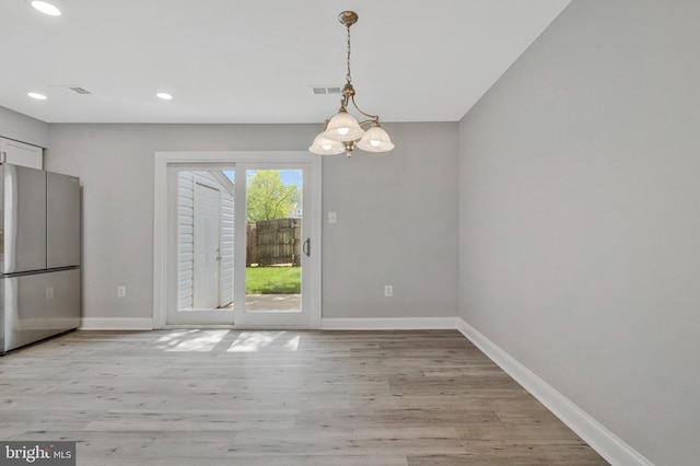 unfurnished dining area with visible vents, recessed lighting, baseboards, and light wood-style floors