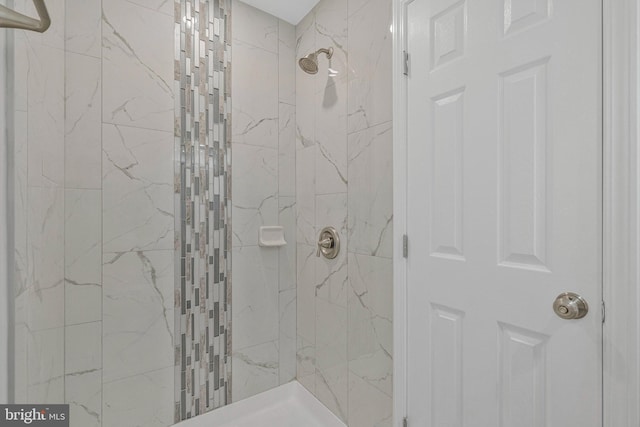 full bath with a marble finish shower