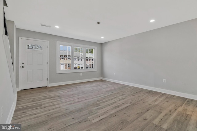 entryway featuring baseboards, recessed lighting, wood finished floors, and visible vents