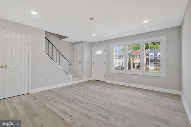 entryway featuring stairs, recessed lighting, baseboards, and light wood-style flooring