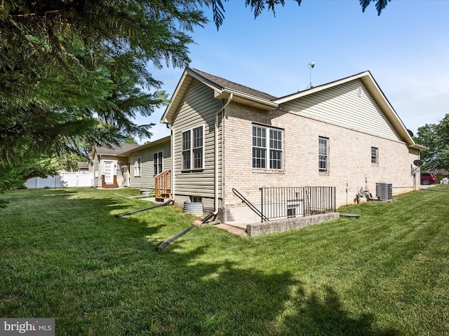 628 Allegheny Cir, Woodstock, VA 22664 - view of property exterior featuring central air condition unit, a yard, and brick siding