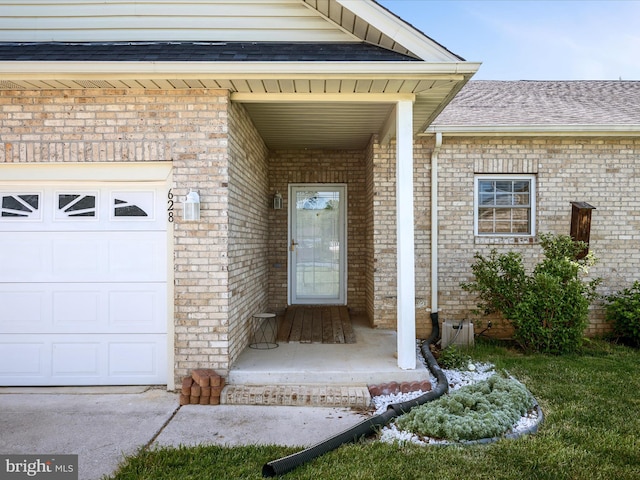 628 Allegheny Cir, Woodstock, VA 22664 - entrance to property featuring a garage, brick siding, and roof with shingles