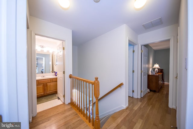 3022 Cascade Dr, Abingdon, MD 21009 - hallway featuring an upstairs landing, light wood-style flooring, a sink, and baseboards