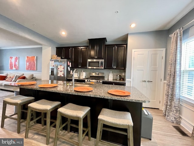 14503 Hunts Farm Rd, Brandywine, MD 20613 - kitchen featuring stainless steel appliances, plenty of natural light, a breakfast bar area, and a center island with sink