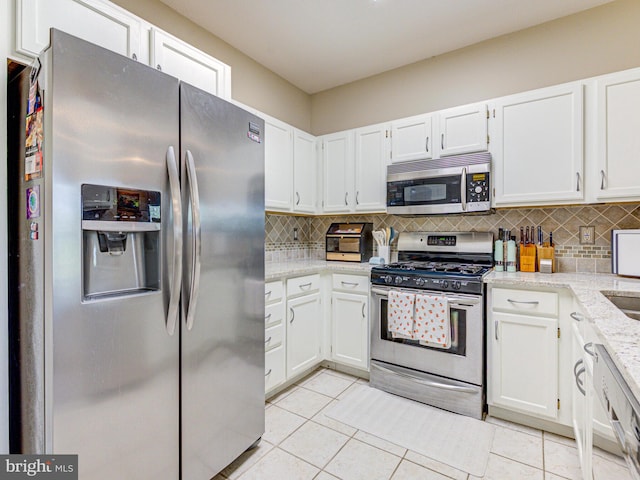 1720 Lake Shore Crest Dr Unit 35, Reston, VA 20190 - kitchen featuring light stone countertops, stainless steel appliances, decorative backsplash, and white cabinets