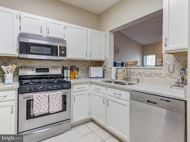 1720 Lake Shore Crest Dr Unit 35, Reston, VA 20190 - kitchen featuring a sink, stainless steel appliances, backsplash, and white cabinets