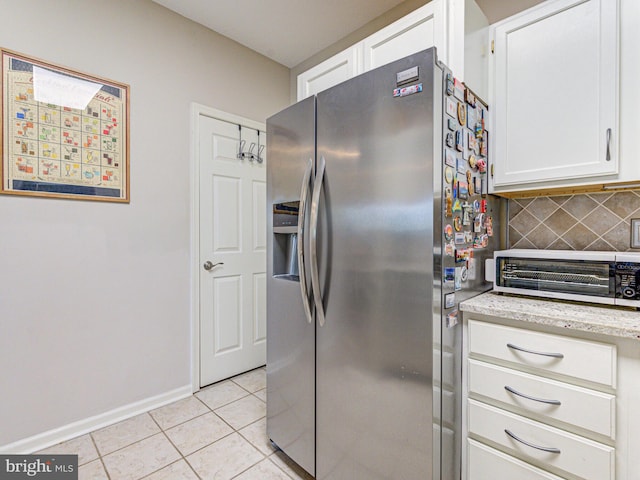 1720 Lake Shore Crest Dr Unit 35, Reston, VA 20190 - kitchen with baseboards, light tile patterned flooring, white cabinetry, stainless steel fridge with ice dispenser, and backsplash