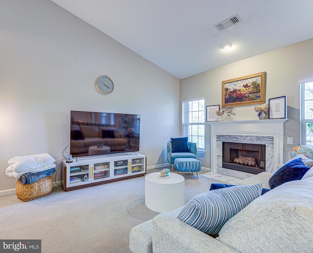 1720 Lake Shore Crest Dr Unit 35, Reston, VA 20190 - carpeted living area with a premium fireplace, vaulted ceiling, visible vents, and a healthy amount of sunlight