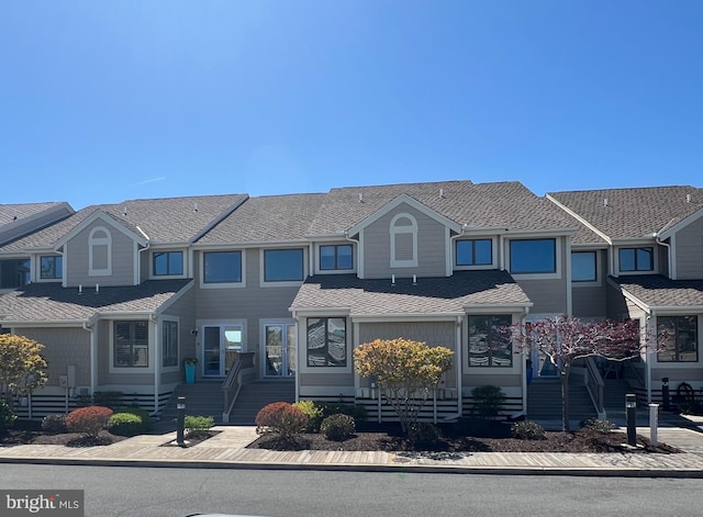townhome / multi-family property with a shingled roof