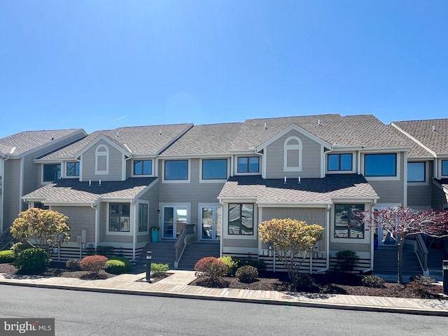 multi unit property featuring a shingled roof